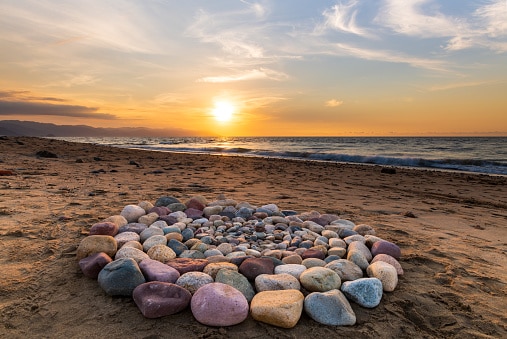 A Group of Stones Are Arranged on the Beach in a Ceremonial Ritualistic Pattern